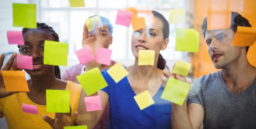Business executives sticking sticky notes